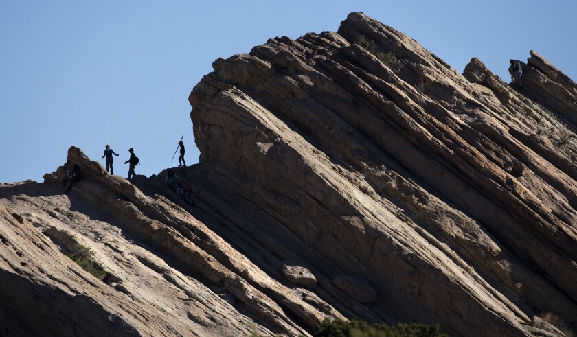 Visitors walk among the jutting rock formations at Vasquez Rocks