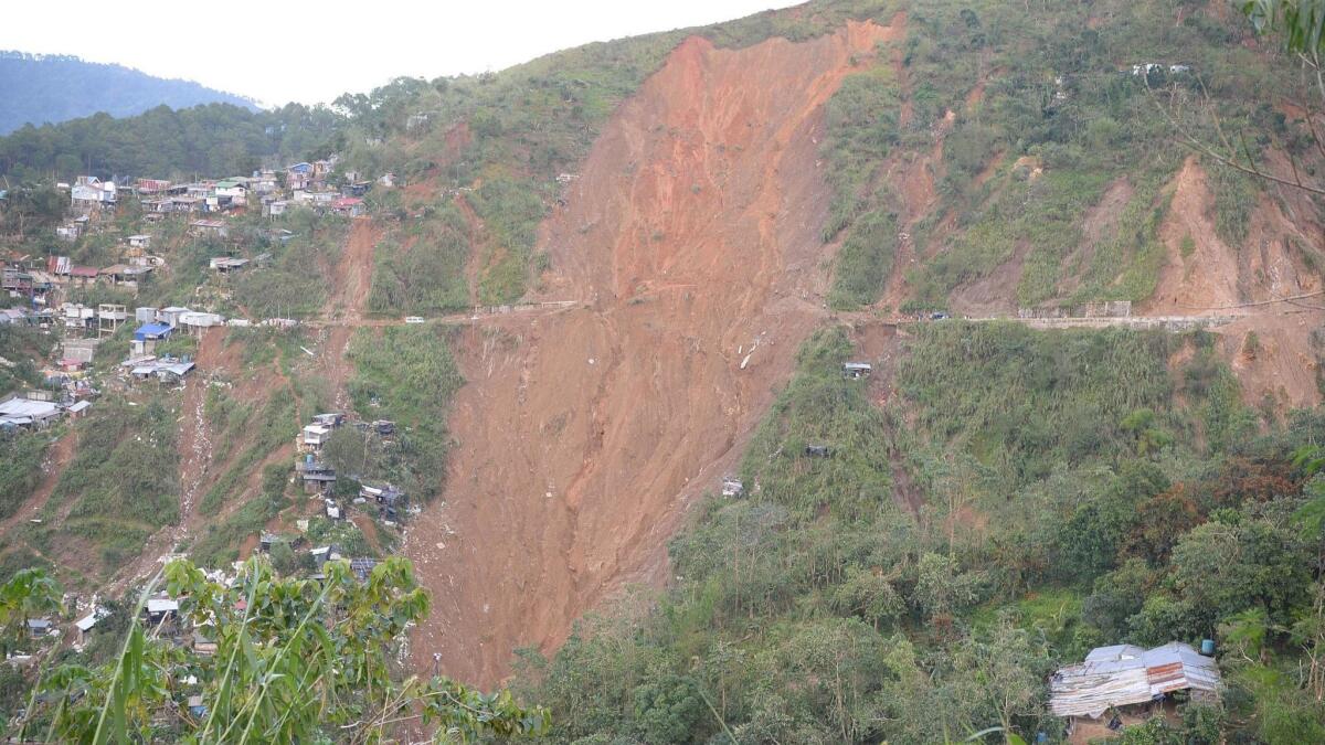 The landslide covers a former miners' bunkhouse that had been turned into a chapel in Benguet province, northern Philippines.