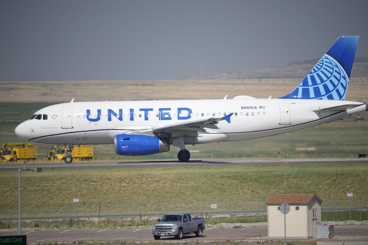 A United Airlines jetliner taxis down a runway for take-off from Denver International Airport in Denver. 