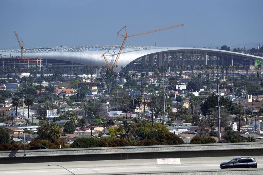 Freeway traffic passes in front of the SoFi Stadium, the new home of the NFL's Los Angeles Chargers and Rams.