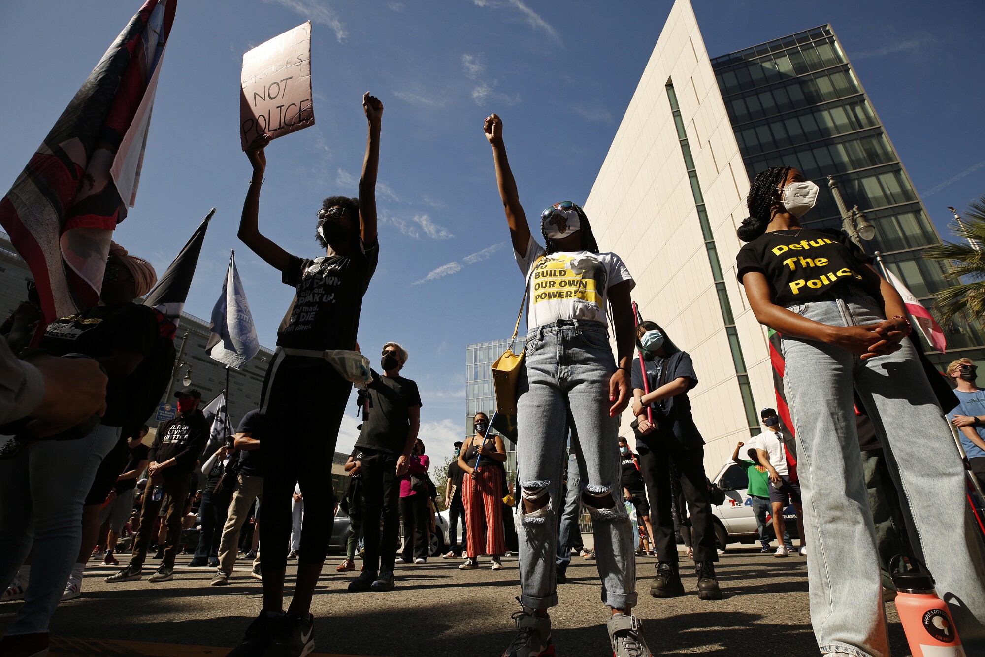People carry flags and signs during a rally.