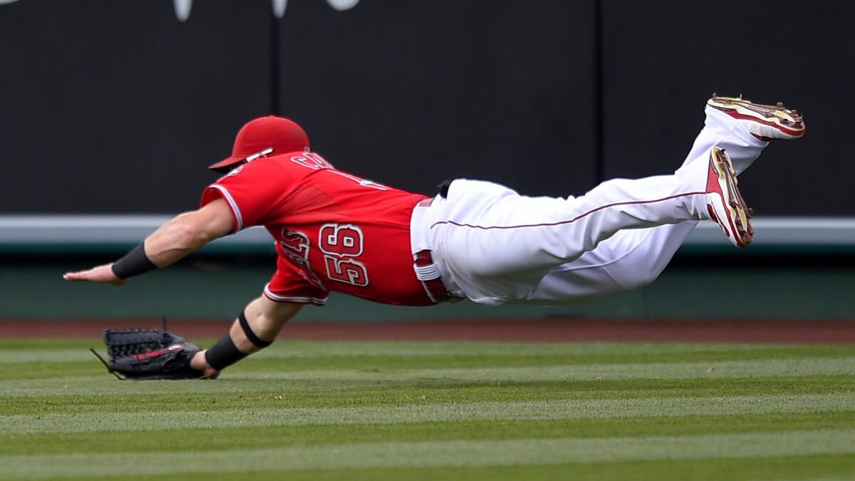 Angels right fielder Kole Calhoun makes a diving catch on a ball hit by the Yankees' Stephen Drew in the fifth inning Wednesday night in Anaheim.