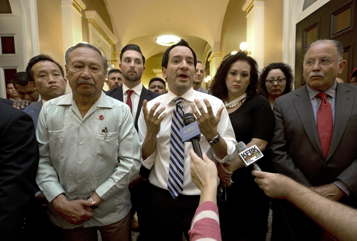 Assembly Speaker Anthony Rendon (D-Paramount) last month speaks in support of the legislation expanding overtime pay for farmworkers. He is flanked by Arturo Rodriguez, president of the United Farm Workers, on the left, and by Assemblywoman Lorena Gonzalez (D-San Diego), the author of the legislation, on the right.