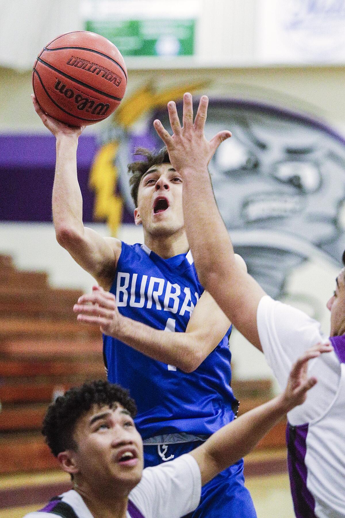 Burbank's Vartan Avetisyan drives to shoot against Hoover in a Pacific League boys' basketball game at Hoover on Friday.