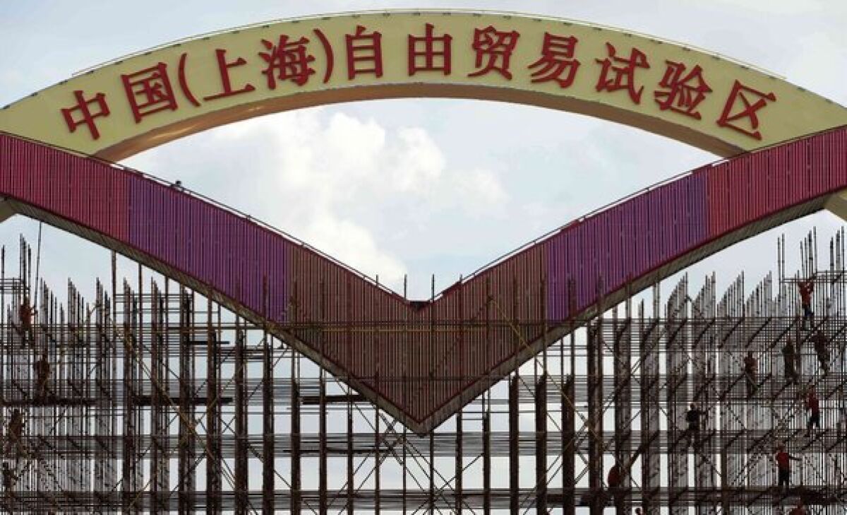 China's first free-trade zone will allow access to Facebook, Twitter and other websites banned elsewhere in the country, a Hong Kong newspaper reported. Above, a sign under construction reads "China (Shanghai) Pilot Free Trade Zone."