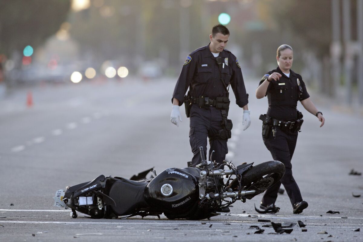 Motorcycle fatalities have fallen slightly in the last year, but are still stubbornly high, a new study said. Here, Downey police investigate a fatal hit run incident at the intersection of Florence Avenue and Paramount Blvd.
