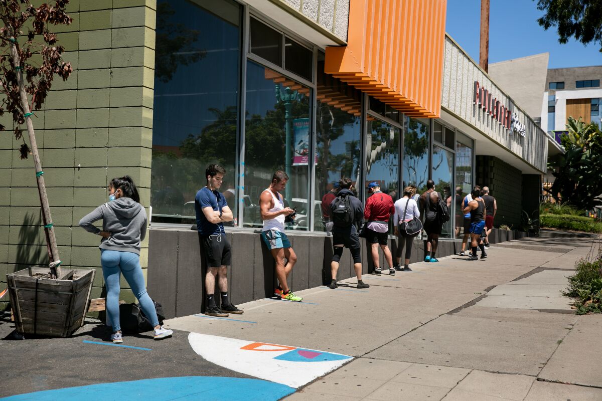 Gym goers line up outside Boulevard Fitness on August 7. The gym remains open even after receiving a closure order.