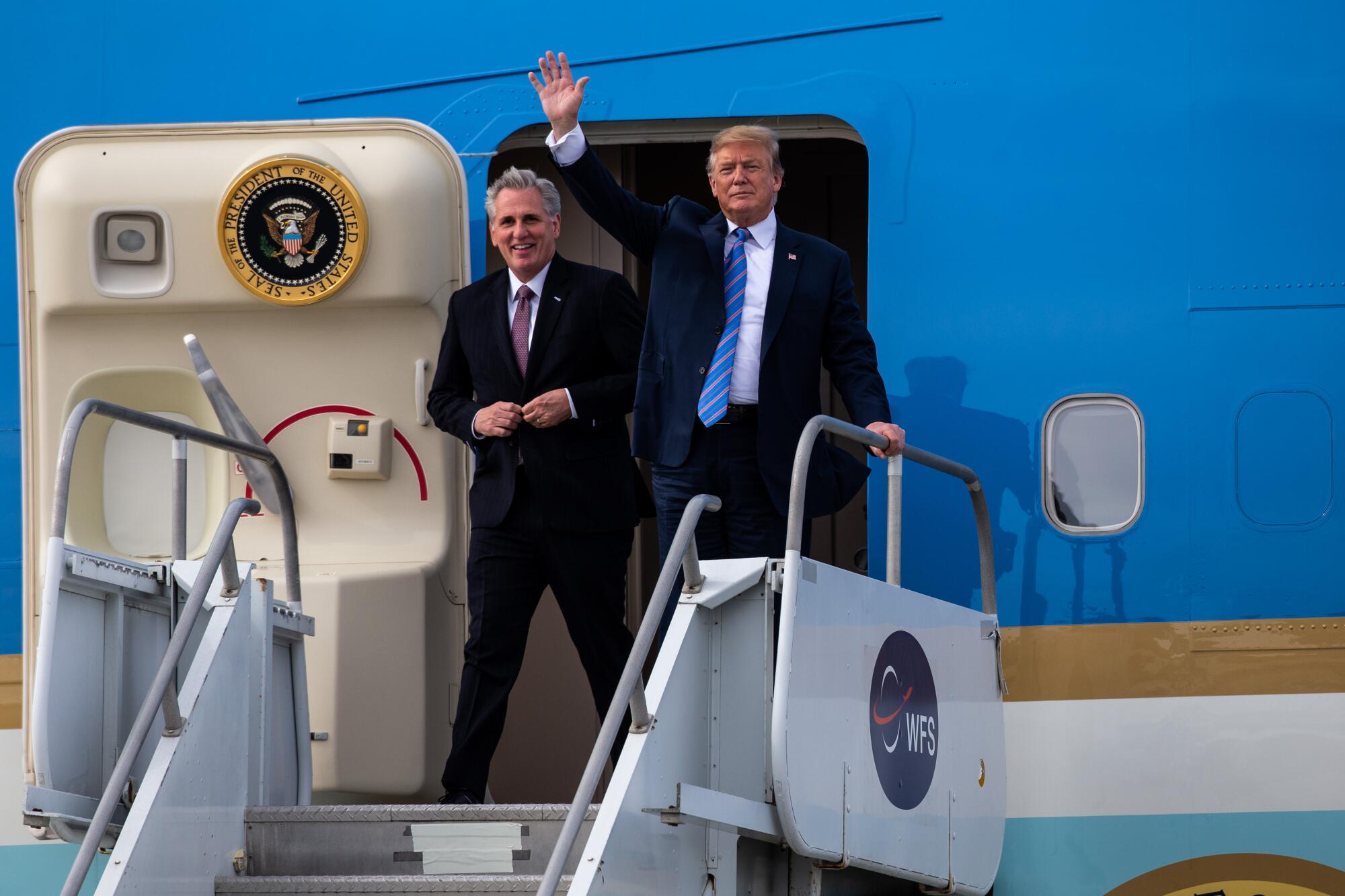 Then-President Trump and Rep. Kevin McCarthy disembark from an airplane.