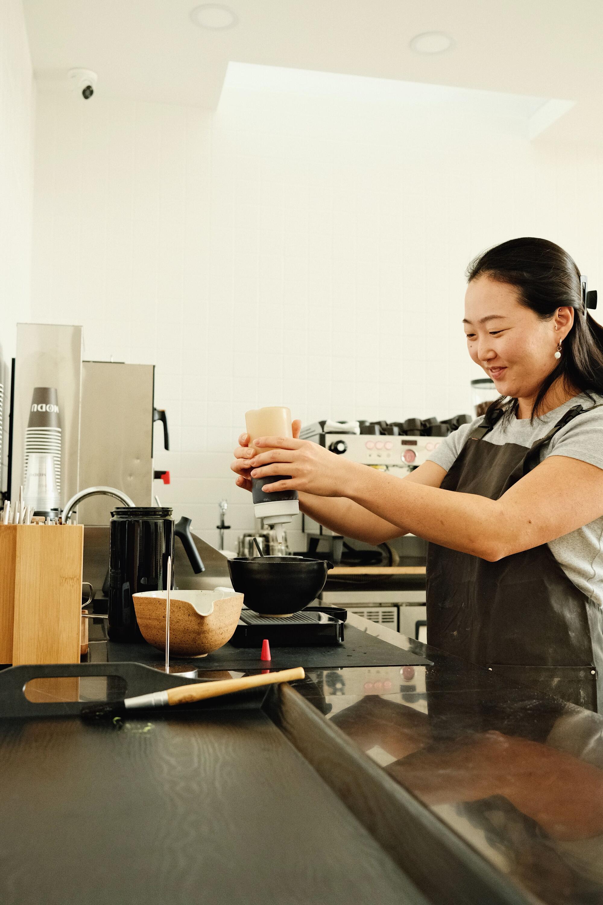 Jiyoon Jang makes matcha at Modu, her coffee shop in Highland Park.