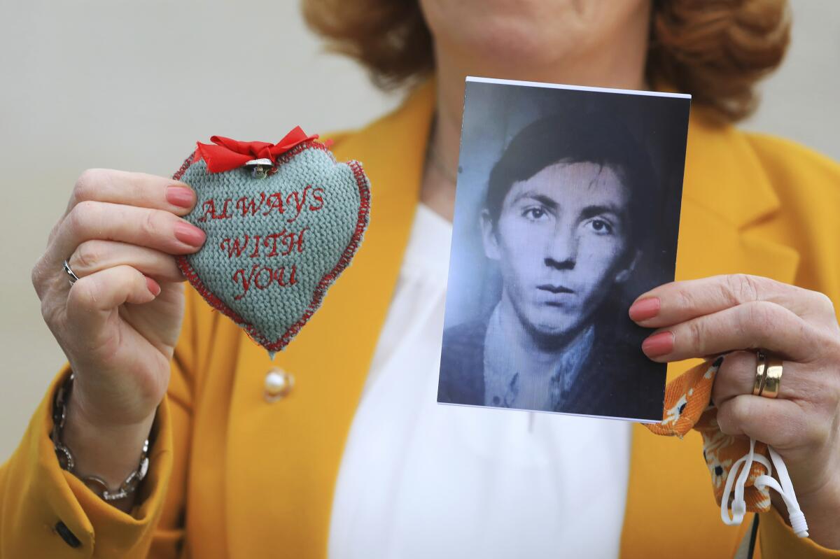 Rita Bonner holds a photograph of her brother John Laverty who was shot in Ballymurphy, ahead of the inquest into the shooting, in Belfast, Northern Ireland, Tuesday May 11, 2021. The findings of the inquest into the deaths of 10 people during an army operation in August 1971 is due to be published on Tuesday. (AP Photo/Peter Morrison)