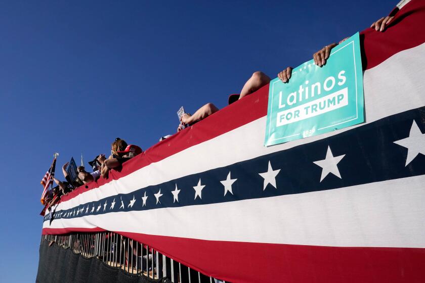 Supporters of President Donald Trump wait for him to speak at a campaign rally in Tucson.