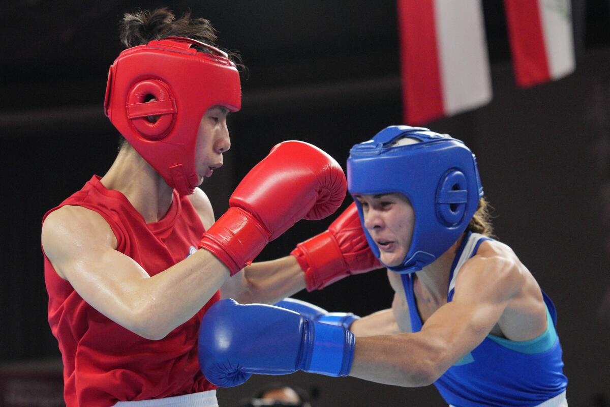 Taiwan's Lin Yu Ting, left, battles Kazakhstan's Karina Ibragimova during a women's 54-57 kilogram boxing final.