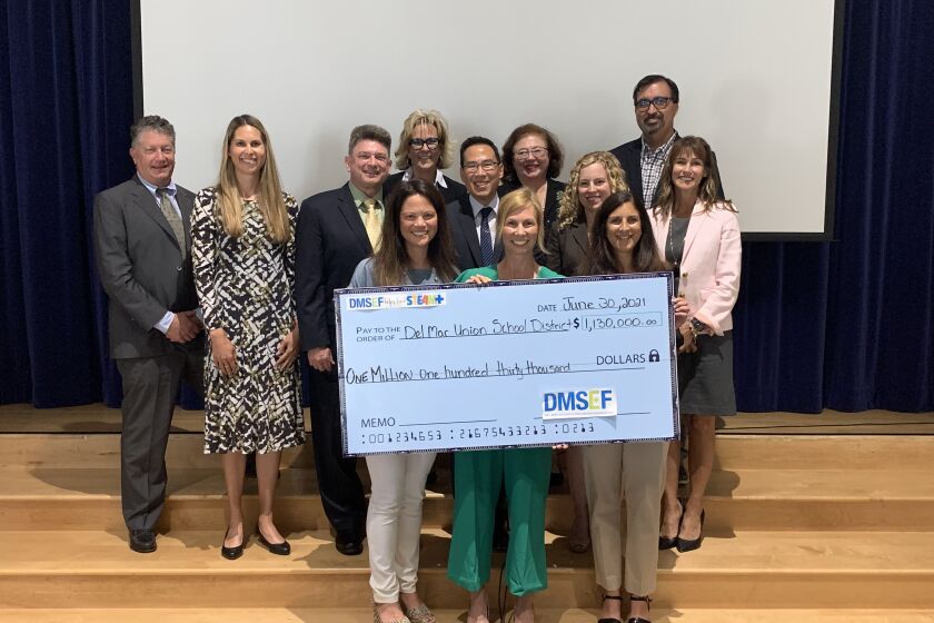DMSEF presented a check to the Del Mar Union School District board on June 30.