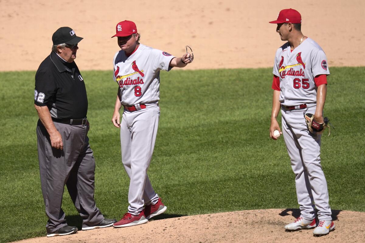 St. Louis Cardinals manager Mike Shildt, center, argues with umpire Joe West.