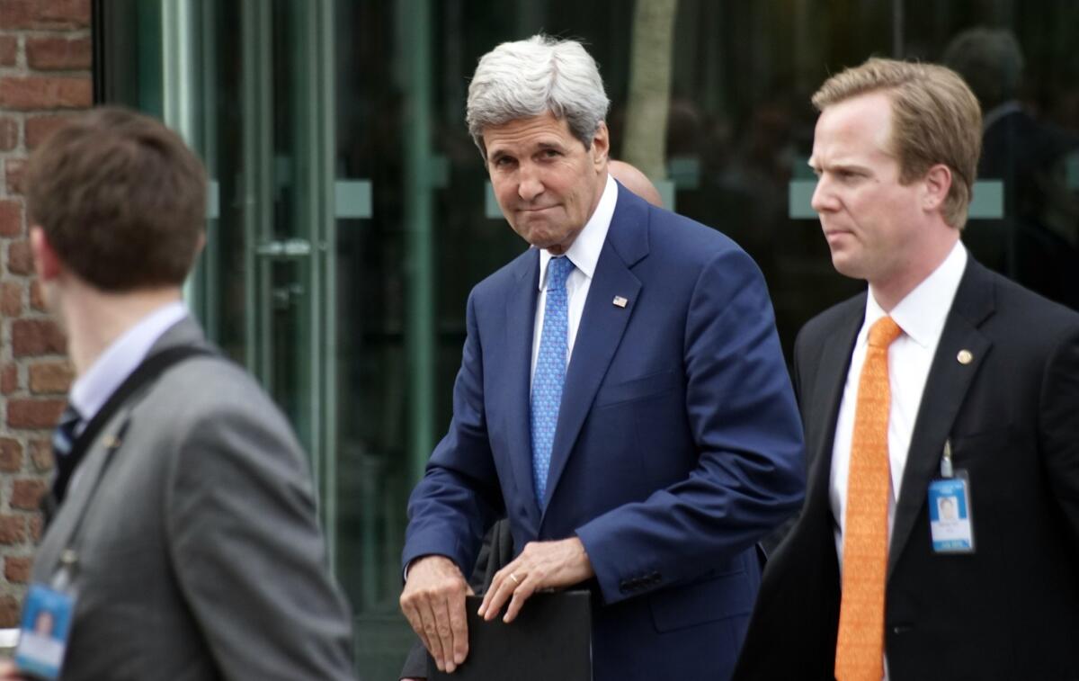 Secretary of State John F. Kerry, center, leaves Palais Coburg in Vienna on Monday after a meeting with Iranian Foreign Minister Mohammad Javad Zarif, on the second day of talks over Tehran's nuclear program.
