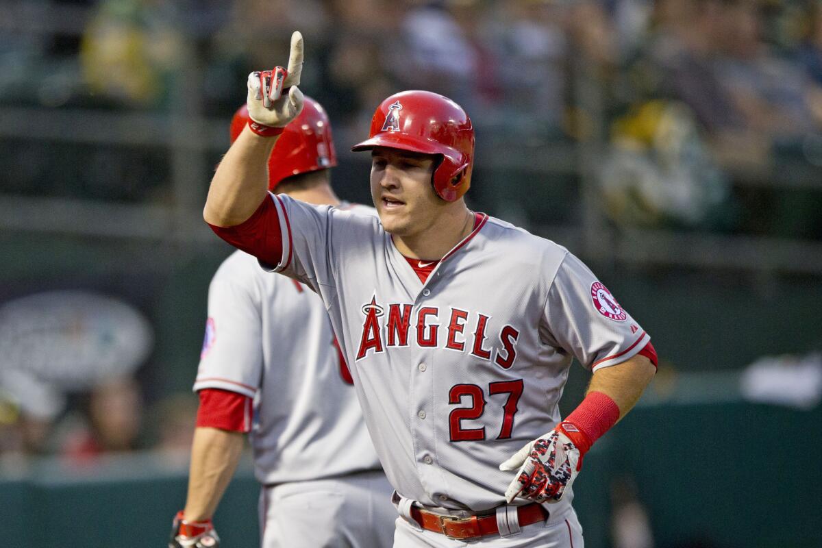 Outfielder Mike Trout celebrates after hitting a home run in the Angels' 6-3 win against the Oakland Athletics. Trout also had a double and drove in three runs.