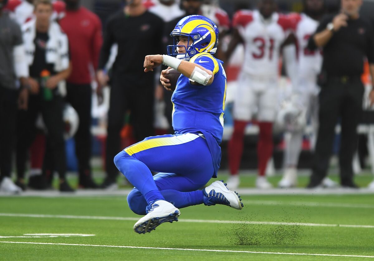  Rams quarterback Matthew Stafford scrambles for a first down against the Cardinals. 