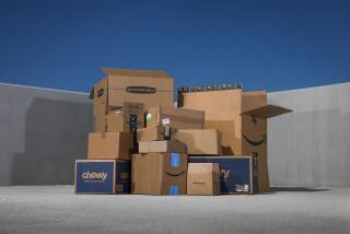 A pile of cardboard boxes on top of concrete under a daytime deep blue sky.