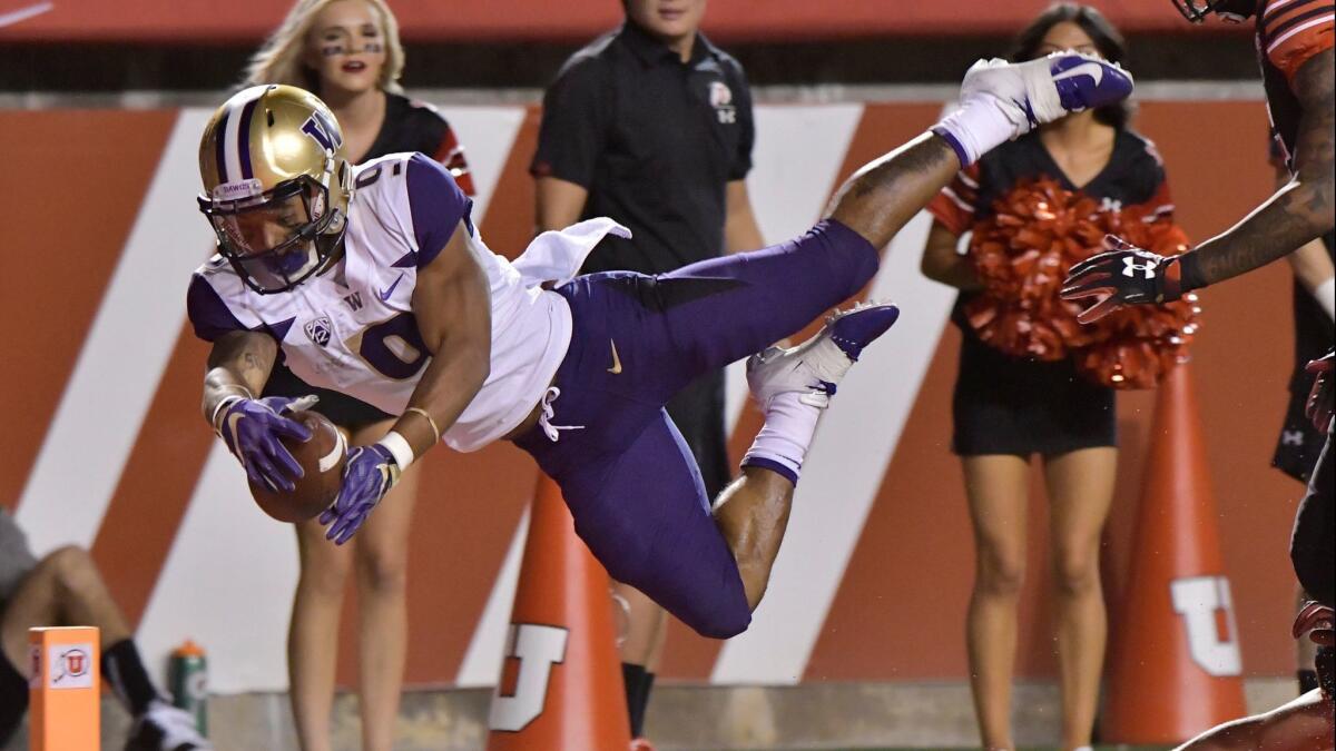 Washington's Myles Gaskin leaps into the end zone against Utah on Sept. 15.