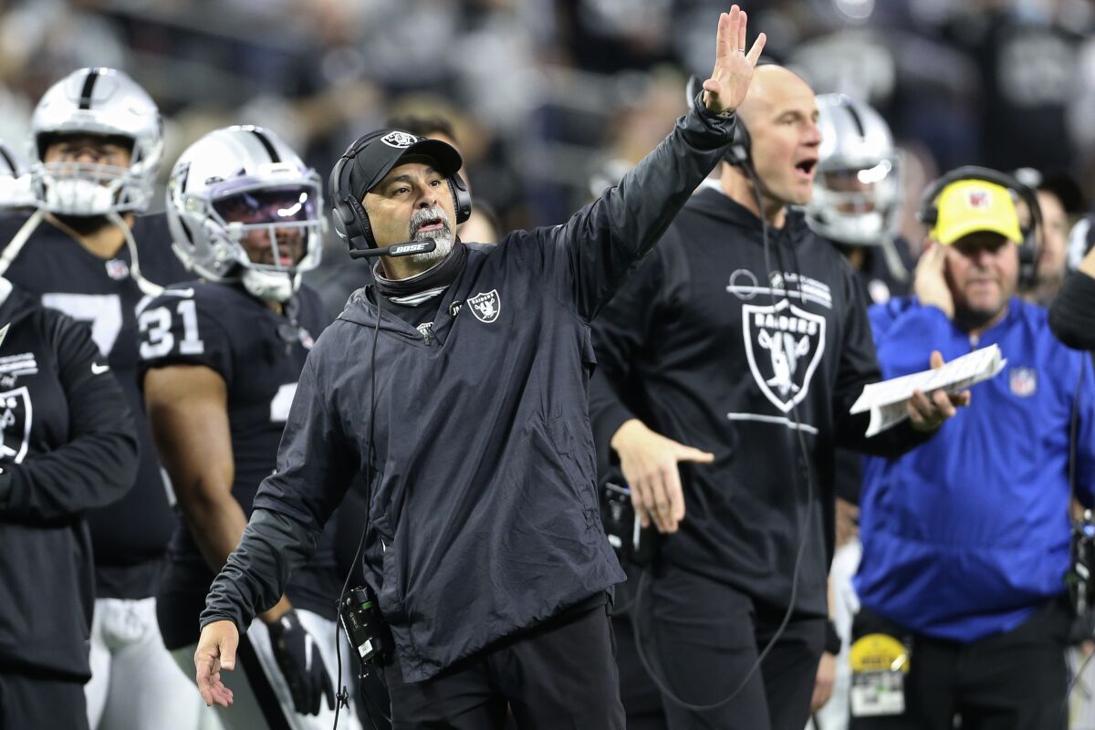 Las Vegas Raiders interim head coach Rich Bisaccia motions towards the field during the second half of an NFL football game against the Los Angeles Chargers, Sunday, Jan. 9, 2022, in Las Vegas. (AP Photo/Ellen Schmidt)