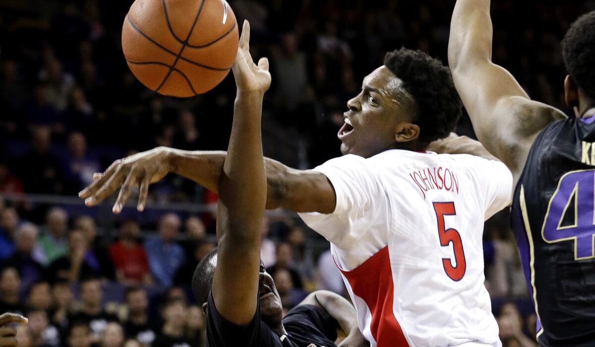 Arizona forward Stanley Johnson (5) blocks a shot by Washington forward Donaven Dorsey in the first half Friday night in Seattle.