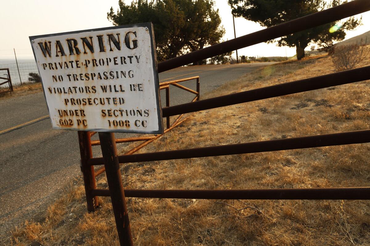 Signs warn of possible trespassing on Hollister Ranch Road. (Al Seib / Los Angeles Times)