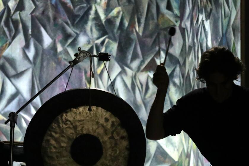 LOS ANGELES, CA -- JULY 29, 2019: Jonathan Hepfer performs against a painting by artist Guillermo Kuitca during the Monday Evening Concerts' "Music as Existential Experience" at Hauser & Wirth. (Myung J. Chun / Los Angeles Times)