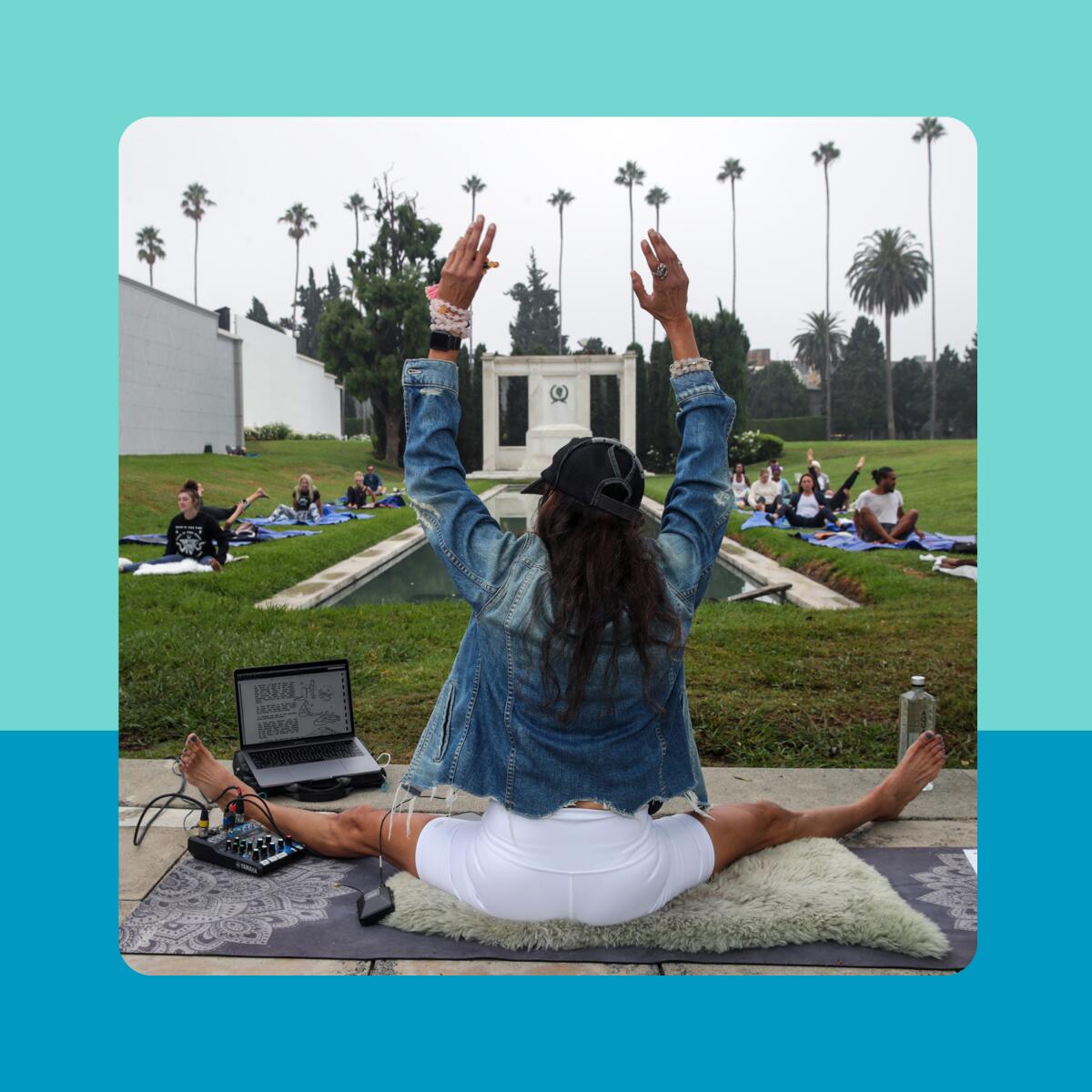 A woman in a sitting pose in front of an outdoor class