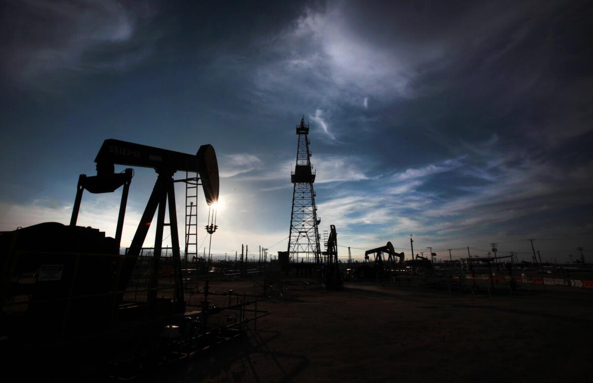 Oil pumps and drilling equipment in an oil field in Kern County.