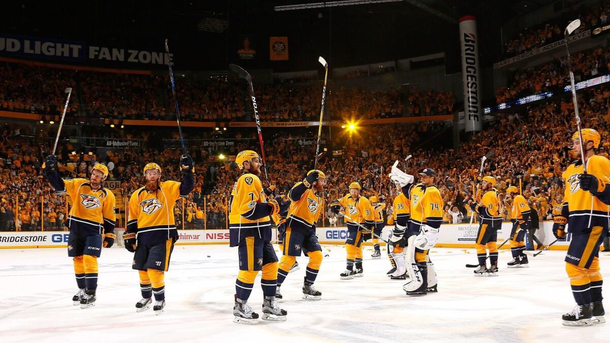 The Nashville Predators raise their sticks to thank the fans after wrapping up their Western Conference semifinal series against St. Louis with a 3-1 victory on May 7.