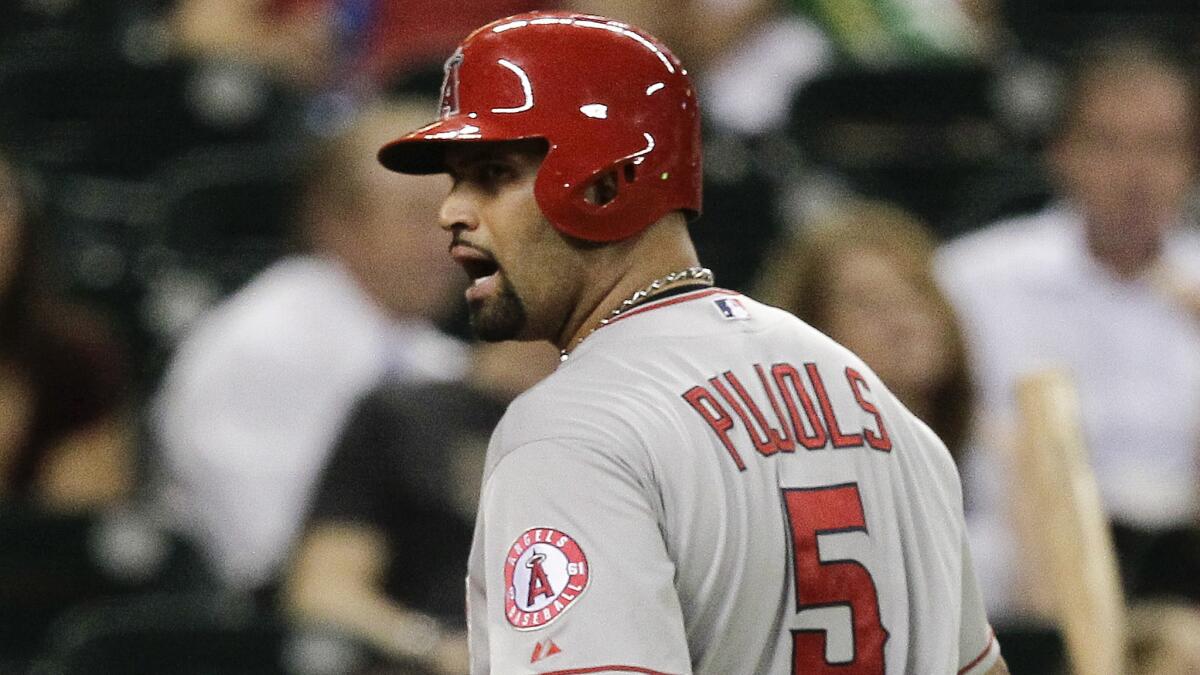 Angels first baseman Albert Pujols has words for home plate umpire Jeff Kellogg after being called out on strikes during the sixth inning of the Angels' 4-1 loss to the Houston Astros on Wednesday.