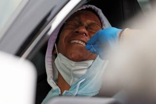 LOS ANGELES, CA - JANUARY 17: A person is given a COVID-19 test during an event sponsored by the Congress of Racial Equality (CORE-CA) Kingdom Day Parade Committee in lieu of its annual parade in Leimert Park on Monday, Jan. 17, 2022 in Los Angeles, CA. Around 500 rapid tests were donated for the event. (Dania Maxwell / Los Angeles Times)