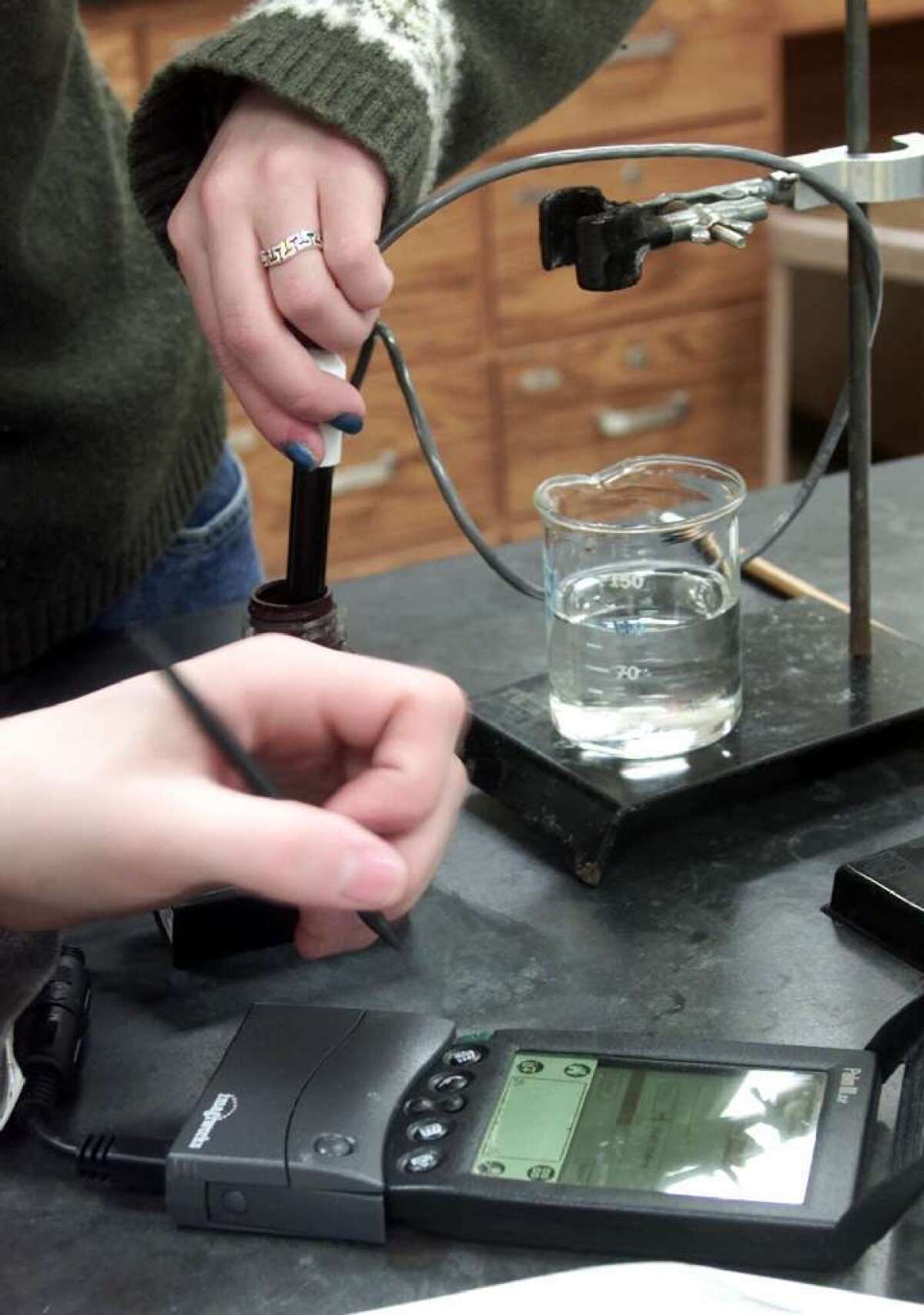 Students run an experiment in a chemistry class at an Illinois high school.