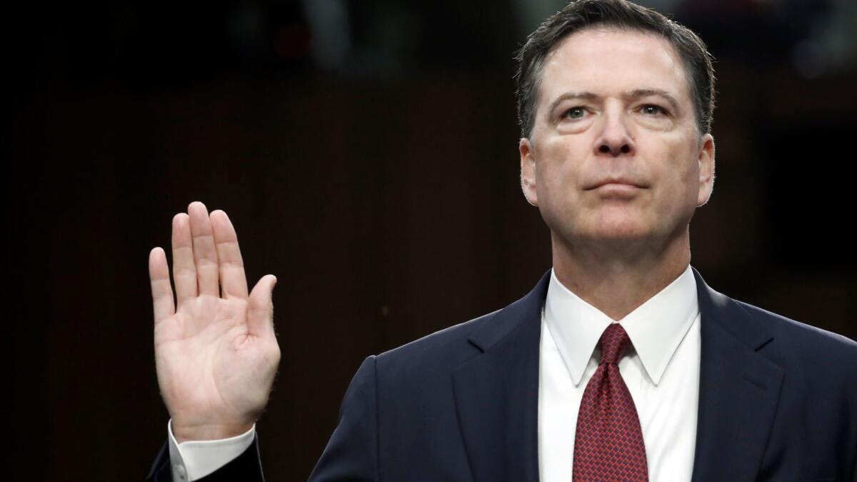 Former FBI Director James B. Comey is sworn in during the Senate Intelligence Committee hearing on Capitol Hill.