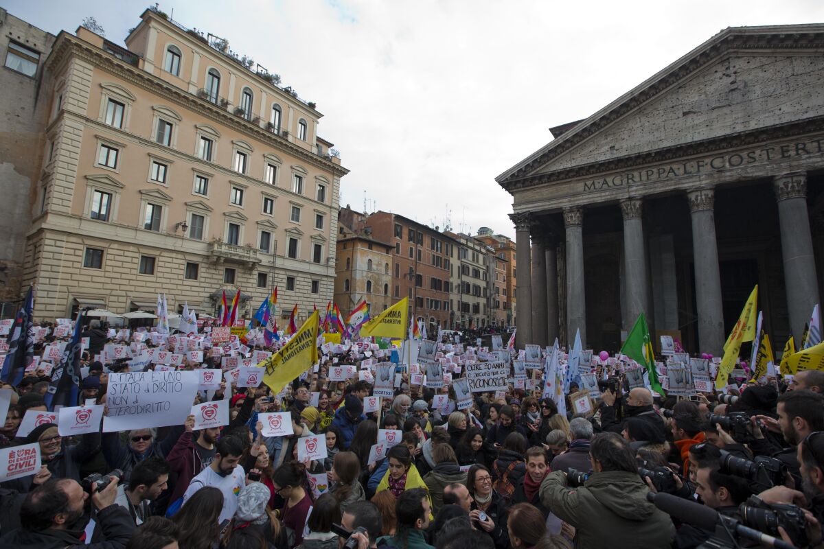 FILE - Activists demonstrate in favour of rights for gay couples, in Rome on Jan. 23, 2016. Italian opposition politicians and gay right activists on Tuesday decried as a step backward moves by Italian Premier Giorgia Melonis far-right-led government to limit recognition of parental rights to the biological parent only in the case of same sex-parents. The city of Milan has been told to stop officially recording both parents in same-sex couples on city registers, the last major city in Italy to do so after a smattering of administrations had briefly embraced the practice of recognizing both parents regardless of sexual orientation. (AP Photo/Andrew Medichini, File)