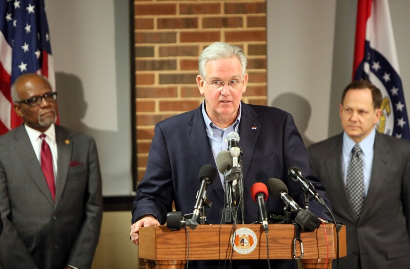 Missouri Gov. Jay Nixon, center, St. Louis County Executive Charlie Dooley, left, and St. Louis Mayor Francis Slay discuss preparations for the announcement of the grand jury decision in the Darren Wilson case.