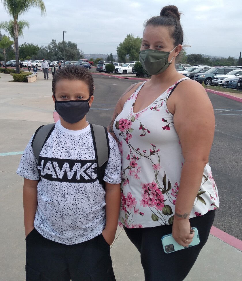 Andrea Garcia takes her son, Michael, to his first day in the third grade at Hanson Elementary School.