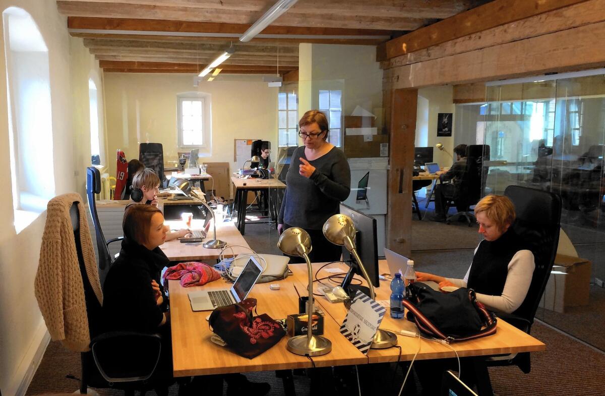 Galina Timchenko, Meduza editor, center, and other journalists work at the Meduza Project office in Riga, Latvia.