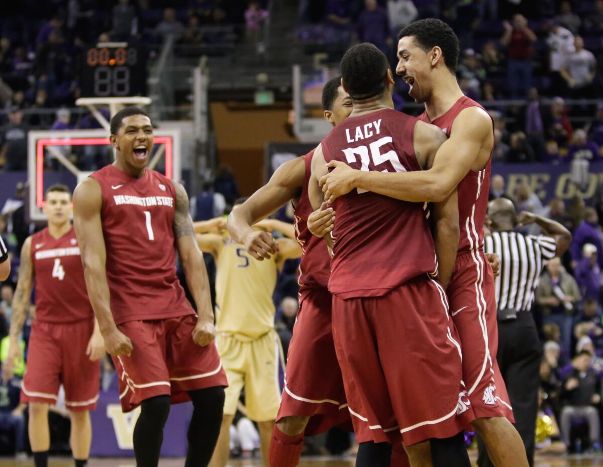 Washington State guard DaVonte Lacy is rushed by his teammates after he hit six straight free throws down the stretch to hold off Washington on Saturday.