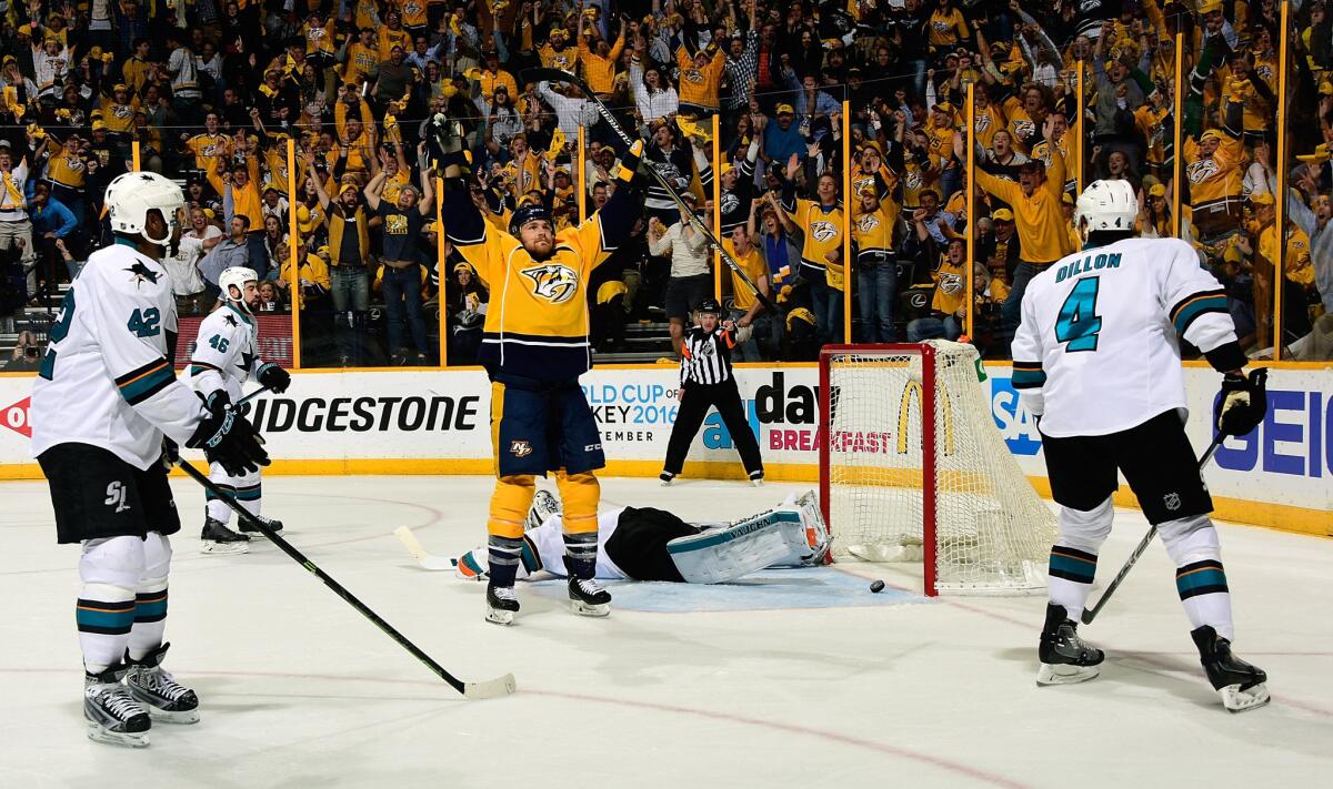 Predators forward Colin Wilson (33) holds his hands up in celebration amidst a cadre of Sharks defenders after scoring the game-tying goal during the third period of Game 6.
