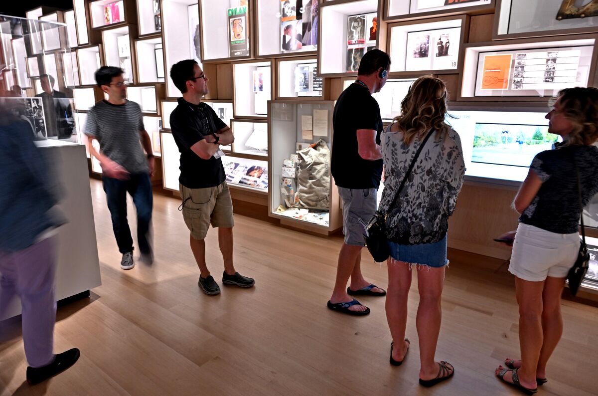 Visitors looking at museum exhibits.