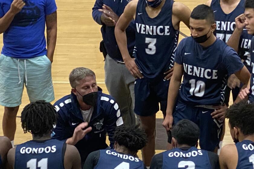 Venice basketball coach David Galley talks to his team.