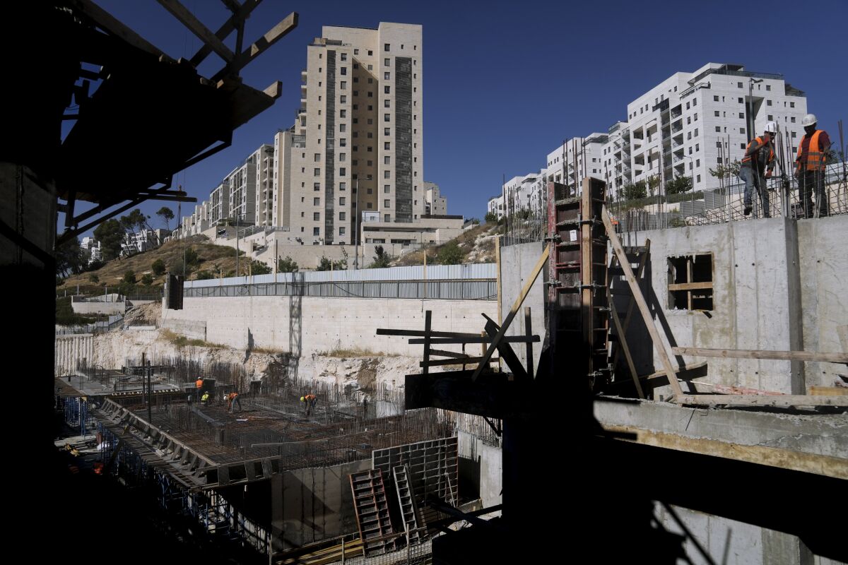 Palestinian laborers work at a construction site in Har Homa, an Israeli settlement in east Jerusalem on Wednesday.