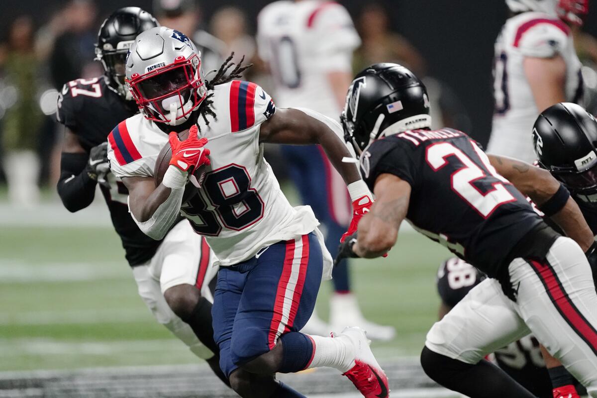 New England Patriots running back Rhamondre Stevenson carries the ball against the Atlanta Falcons.