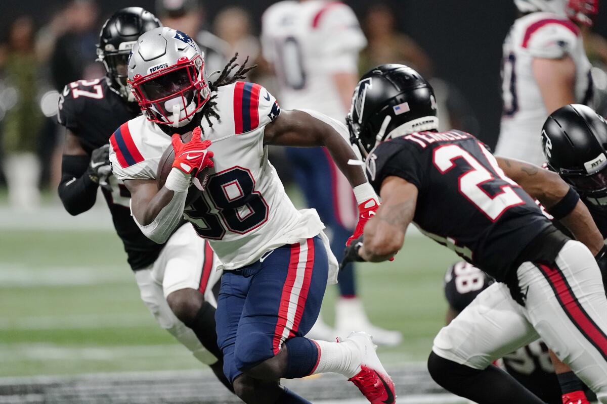 New England Patriots running back Rhamondre Stevenson carries the ball against the Atlanta Falcons.