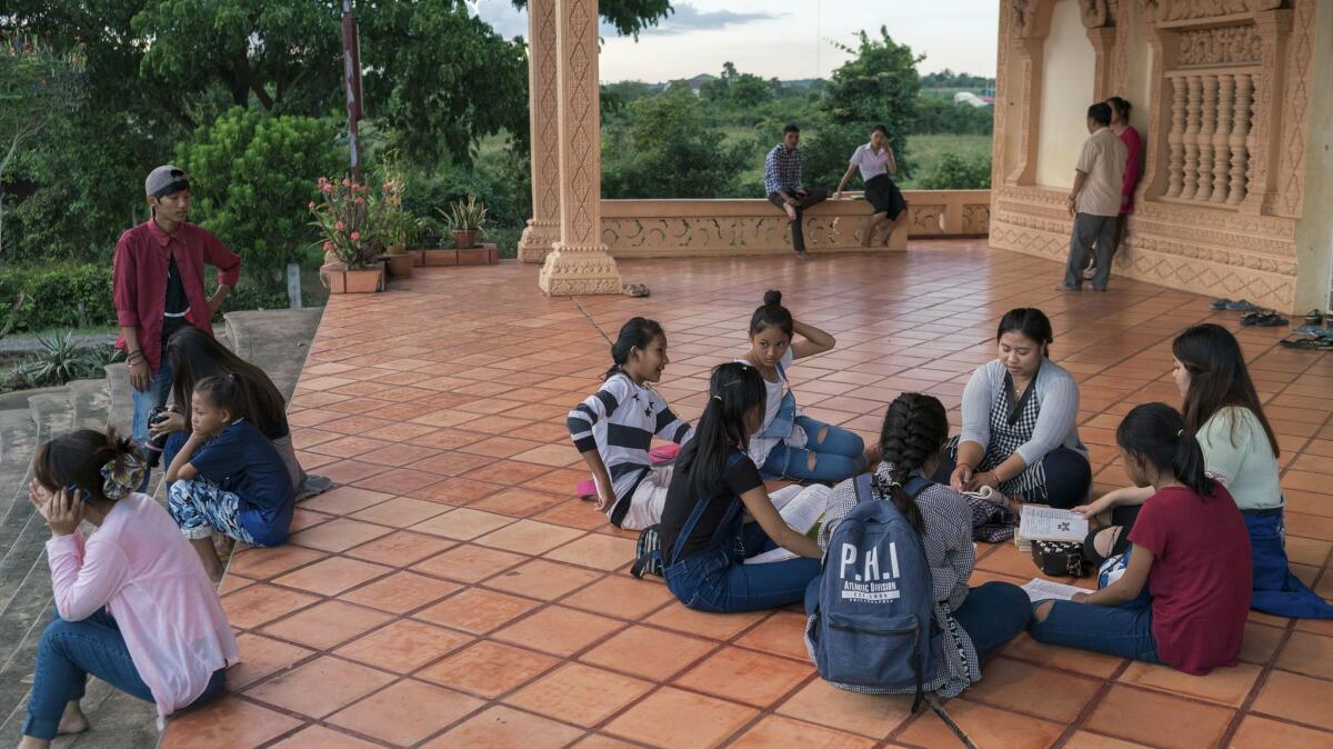 Youth wait oustide the Marist church of Pailin at the beginning of the Saturday's service. Pailin, a town of 70,000 people, is home to 22 churches.