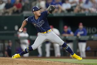 Tampa Bay Rays relief pitcher Robert Stephenson winds up to deliver to a Texas Rangers.