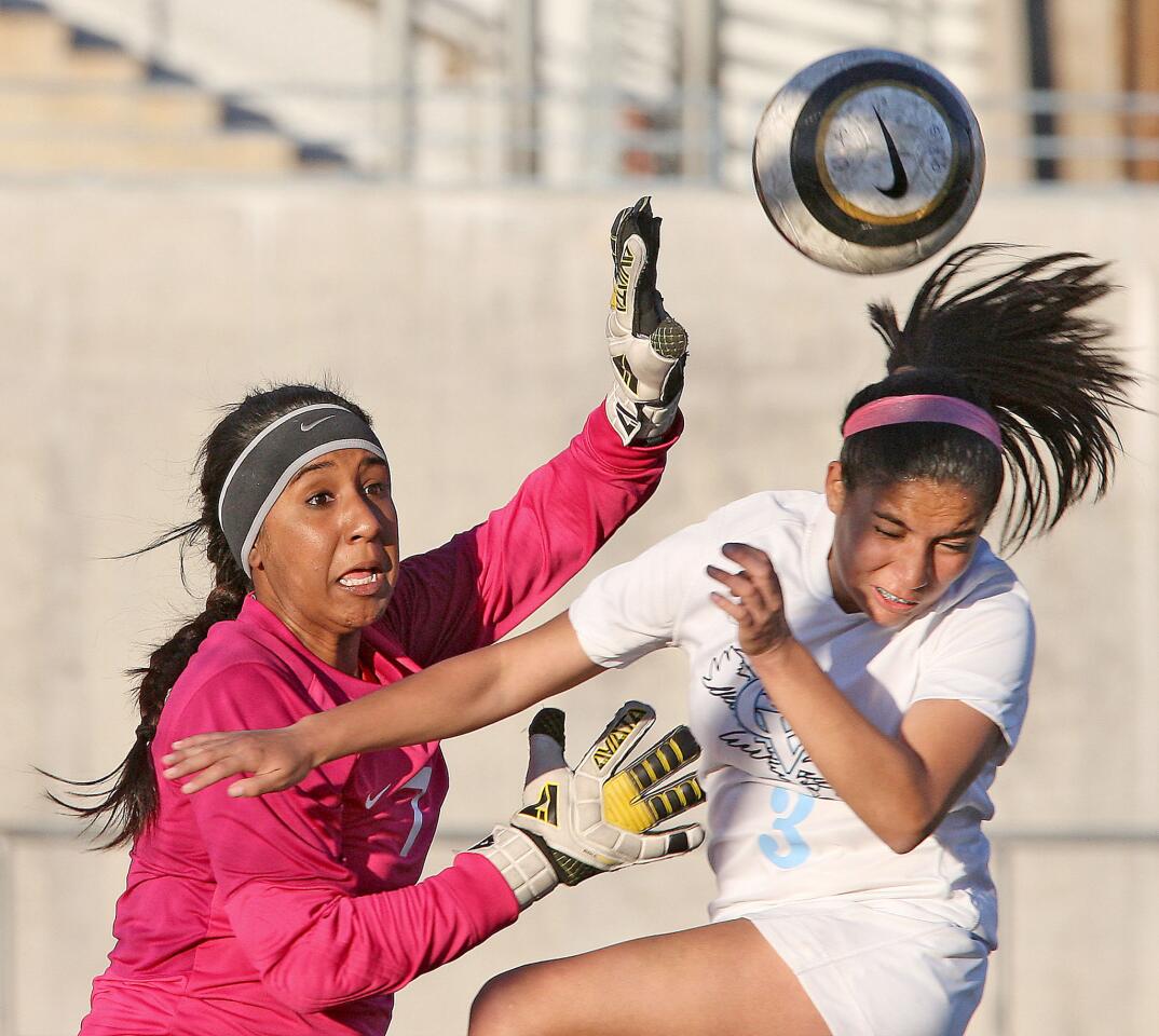 Burroughs' goalie Taylor Bailey stops a goal attempt by CV' s Izzy Costilla during a match at CV on Monday, February 3, 2014.