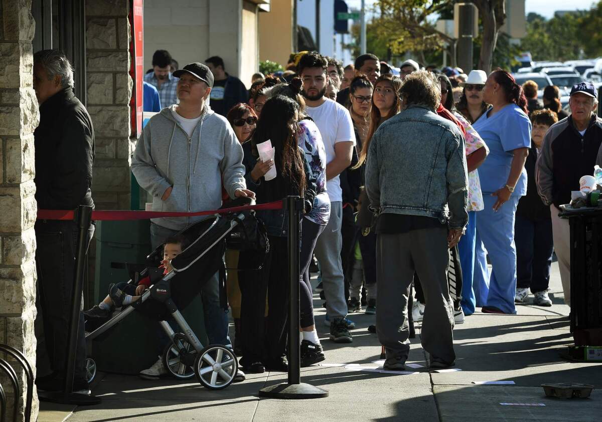 People line up to buy California Powerball lottery tickets at the famous Bluebird Liquor store, considered to be a lucky retailer of tickets in Hawthorne.