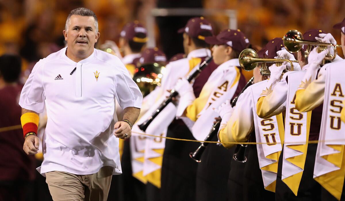 Arizona State Coach Todd Graham runs onto the field before a game against Washington State on Saturday.